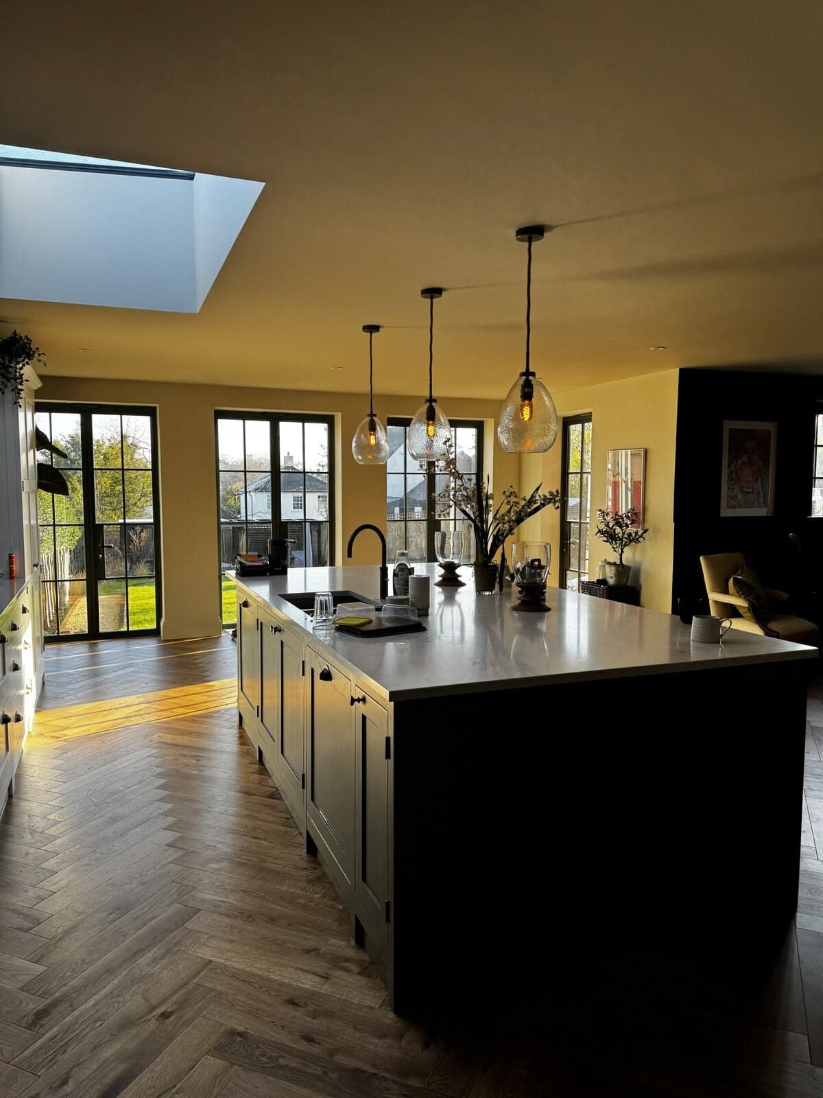 The kitchen looking out to the garden through full-height glazing