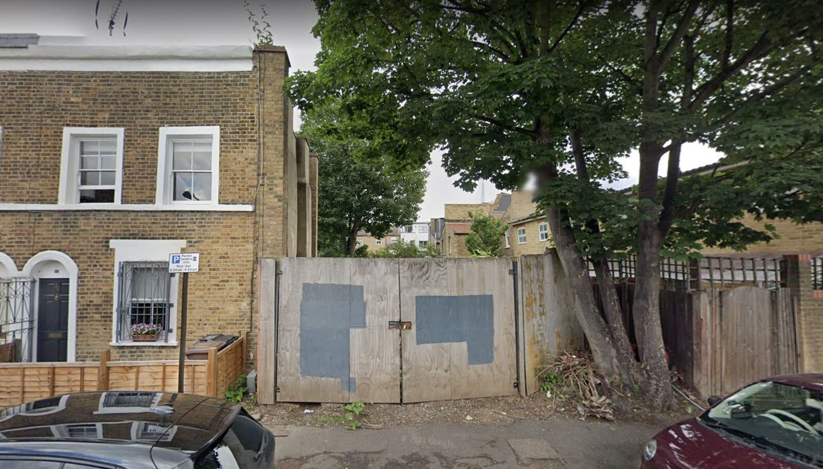 The vacant hoarded corner plot before development