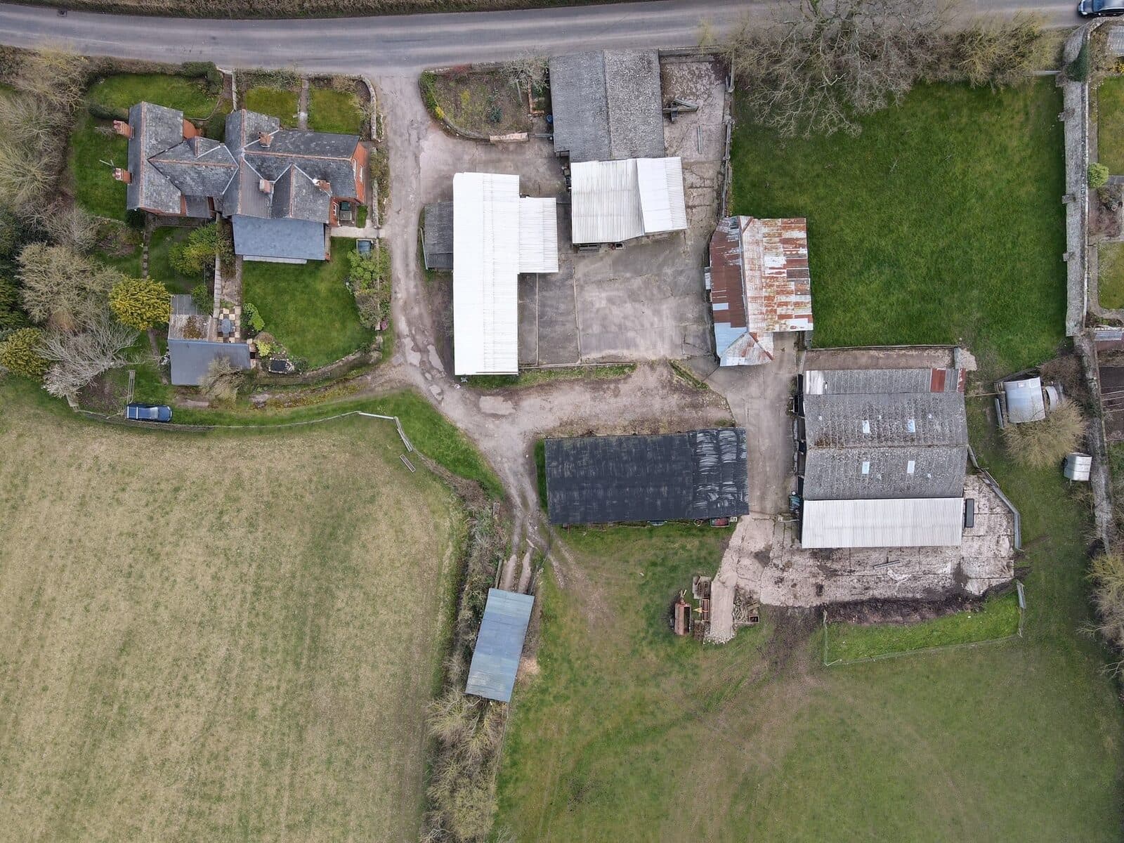 Aerial view of the farm with the barn to the rear of the farmhouse